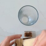 Top the cookie crust in each cup with a layer of the cheesecake filling mixture for the High Protein Biscoff Cheesecakes
