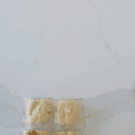 Add layer of crushed lotus biscuits for the High Protein Biscoff Cheesecakes
