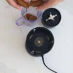 Adding biscoff lotus biscuits to blender to make the Biscoff Crust