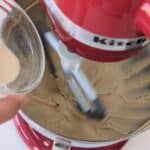 Adding ingredients to bowl to make cheesecake filling for High Protein Biscoff Cheesecakes