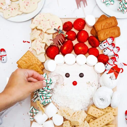 santa-buttercream-frosting-board- dipping cookie in