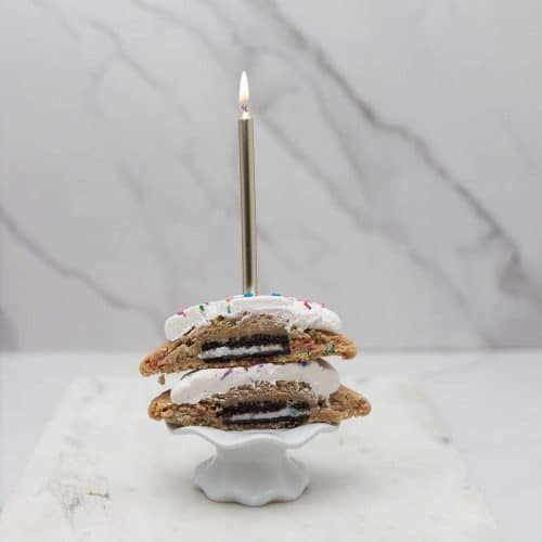 birthday cake cookie cut open with oreo inside and candle on top