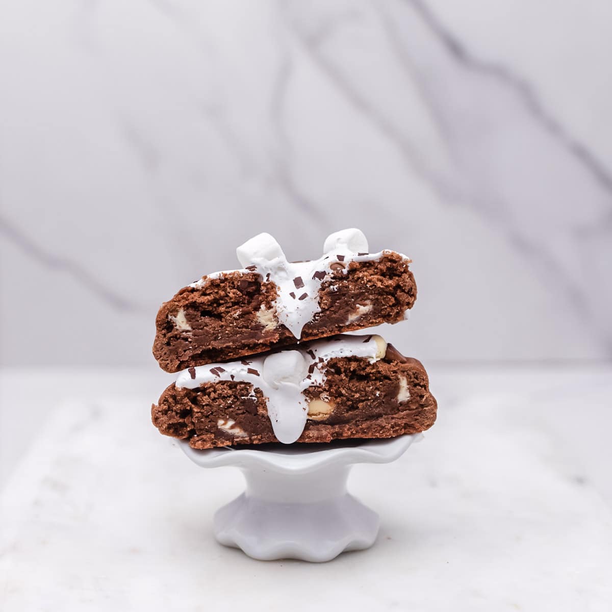 Hot Cocoa Marshmallow Fluff Stuffed Cookie halves stacked on top of each other to show filling