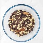 butter, brown sugar and flour, eggs mixed together with chocolate chips to mix in hot chocolate cookies
