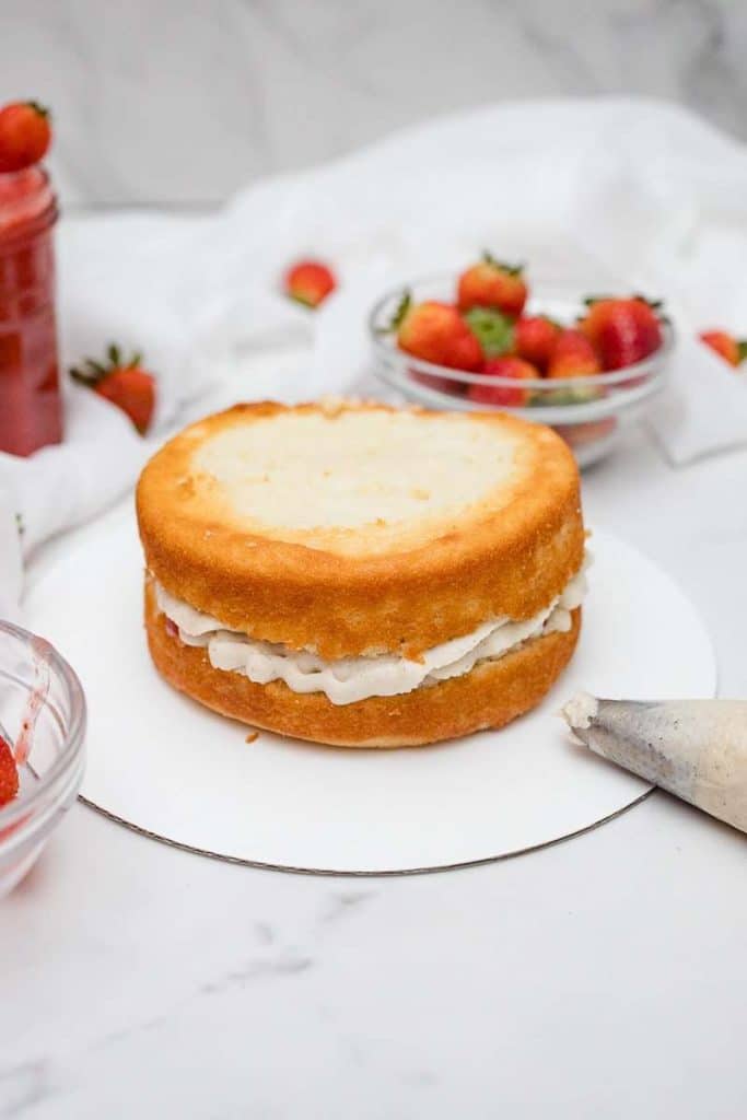 Strawberry Shortcake layer 1 with chantilly cream, strawberries & strawberry sauce inbetween 2 layers