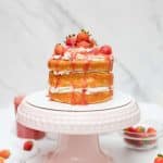 completed strawberry shortcake on cake stand