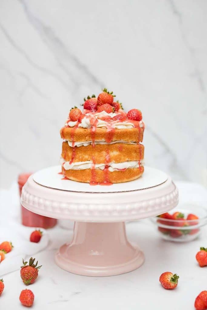completed strawberry shortcake on cake stand