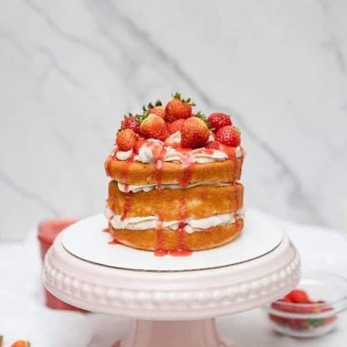 strawberry shortcake cake on pink cake stand