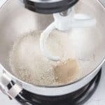 Next, mix the flour, yeast, and brown sugar together in a stand mixer bowl with the dough hook attachment