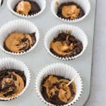 swirl batter and peanut butter for snickers cupcakes with toothpick