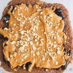 peanut butter layer added to snickers date bark topped with peanuts