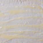 Melted butter spread evenly over rolled dough for tangzhong cinnamon rolls