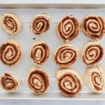 Cinnamon rolls arranged in a greased baking pan