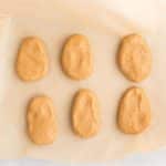 cashew butter Reese eggs shaped on parchment lined baking sheet for freezing