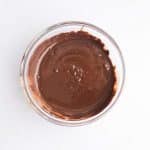 melted dairy free chocolate chips and coconut oil in bowl for cashew butter Reese eggs