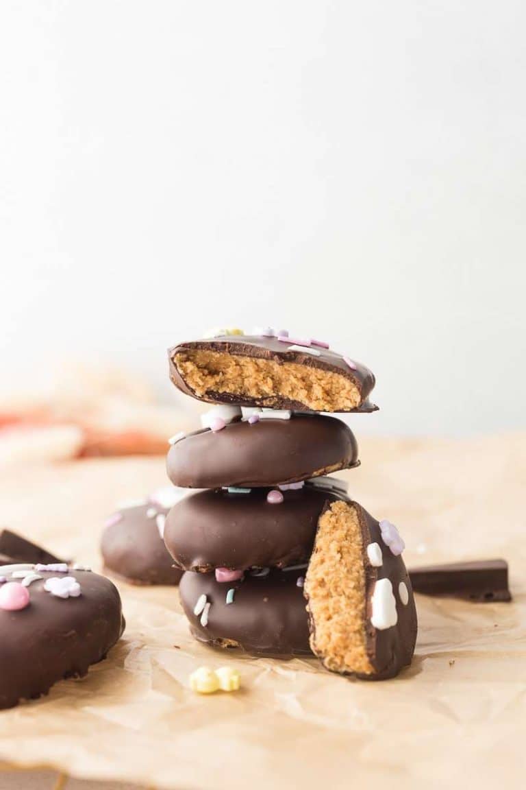 Cashew Butter Reeses Eggs stacked on top of each other; one bitten open to show the inside