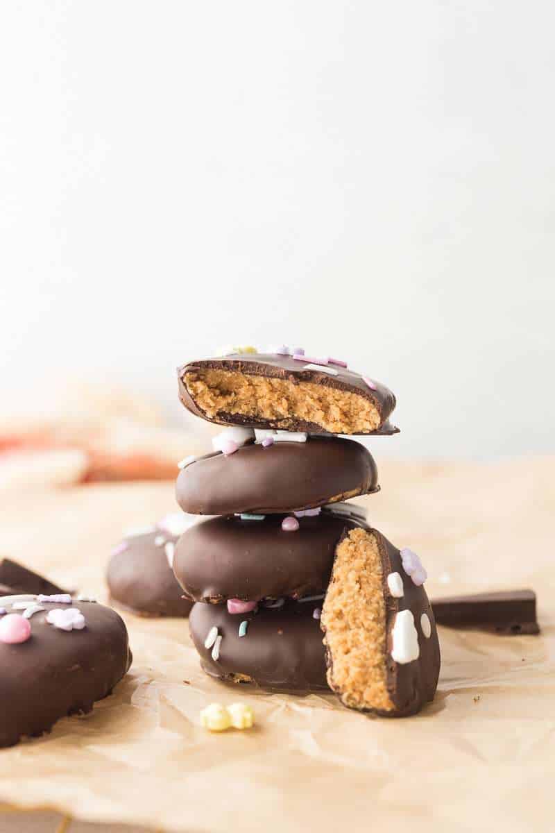 Cashew Butter Reeses Eggs stacked on top of each other; one bitten open to show the inside