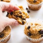 hand holding piece of High Protein Chocolate Chip Muffins showing inside texture