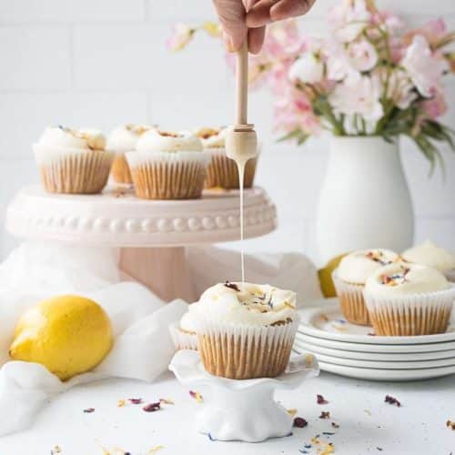 closeup on honey lemon cupcake being drizzled with honey
