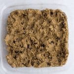 high protein chickpea blondies batter spread out in 8x8 glass baking pan before baking