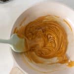 honey and almond butter being heated in small saucepan over low heat