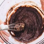 In a microwave-safe mug or ramekin, mix the sunflower seed butter, maple syrup, and oat milk. Add the cocoa powder, protein powder, almond flour, baking powder, and salt. Stir until smooth.