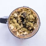 Hemp protein, coconut oil and crushed rice cake pieces in food processor.