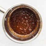 coconut sugar toffee bubbling in a saucepan for making Date Bark