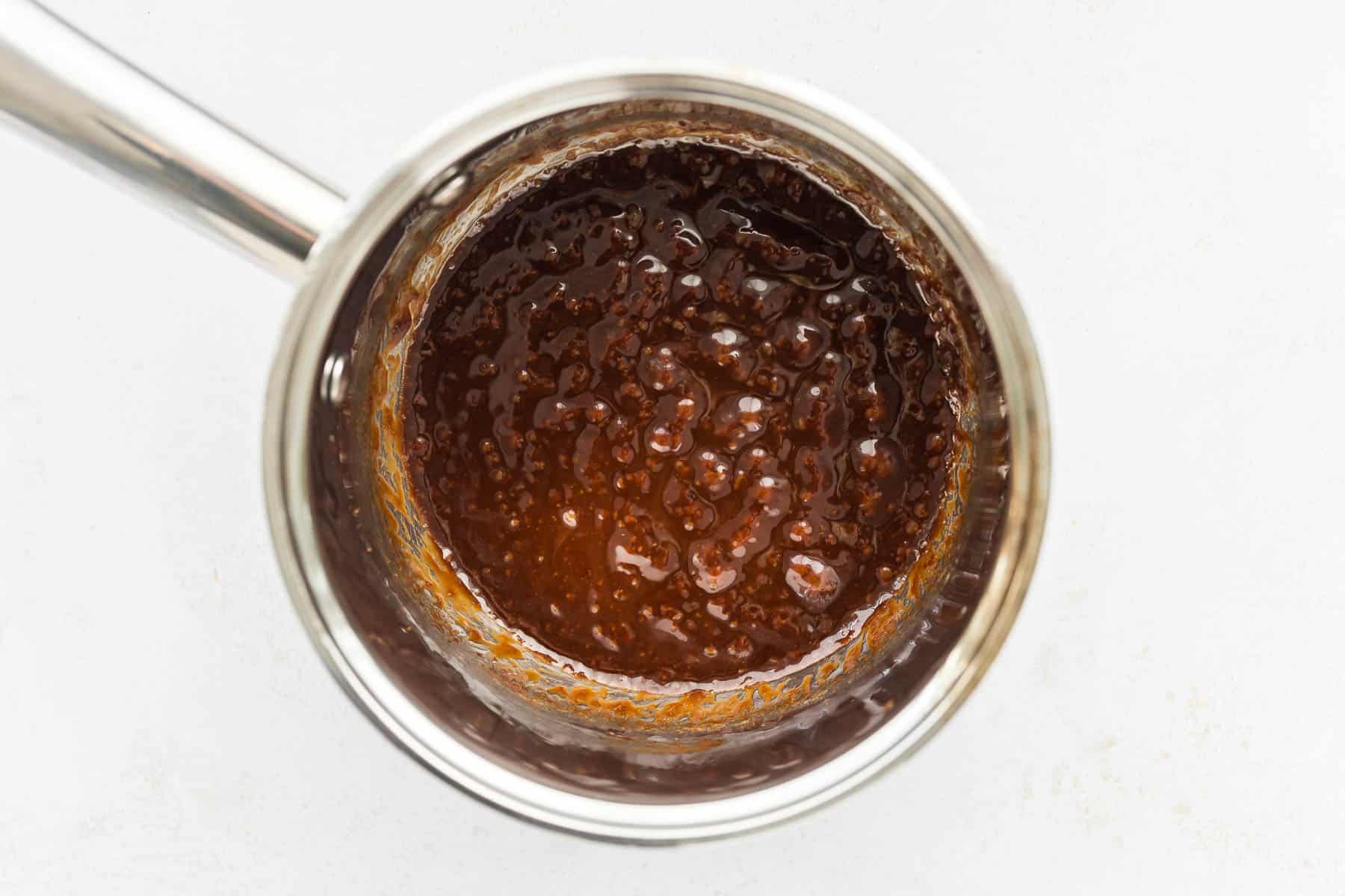 coconut sugar toffee bubbling in a saucepan for making Christmas Crack Date Bark