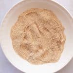 Mixing almond flour, coconut flour, protein powder, coconut sugar, baking powder, and salt in a bowl for sugar cookie protein bars.
