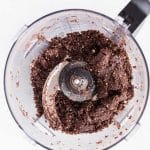 Blending protein powder, oats (or almond flour), cocoa powder, peppermint extract in a food processor to make chocolate peppermint energy balls.