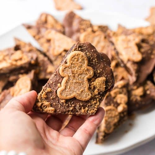Easy gingerbread Christmas crack date bark for cookie exchanges piece held up by hand