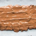Melted chocolate poured onto date bark