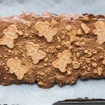 Sprinkled crushed gingerbread cookies on chocolate layer