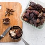 Medjool dates on cutting board being pitted