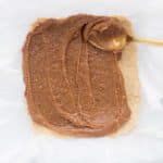 Spreading the date caramel layer evenly over the cookie base