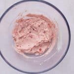 In a medium bowl, add the softened cream cheese, Greek yogurt, maple syrup, and freeze-dried strawberry powder. Mix until smooth and creamy. Fold in the finely chopped fresh strawberries.