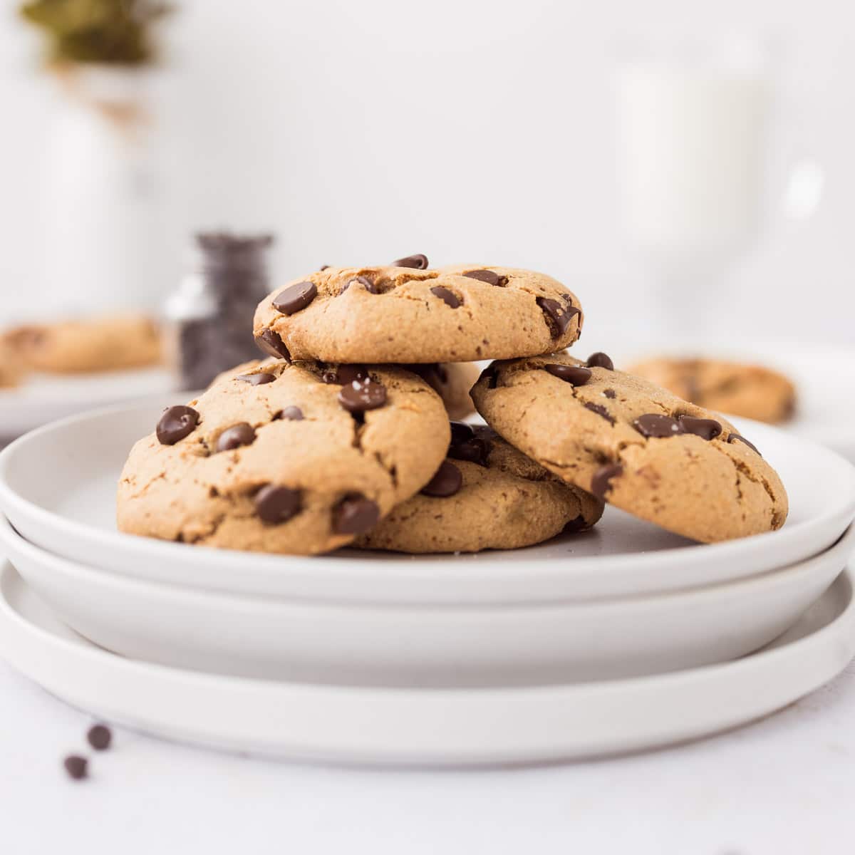 Chewy chocolate chip protein cookies on a white plate, gluten free and refined sugar free with soft centers and melted chocolate chips