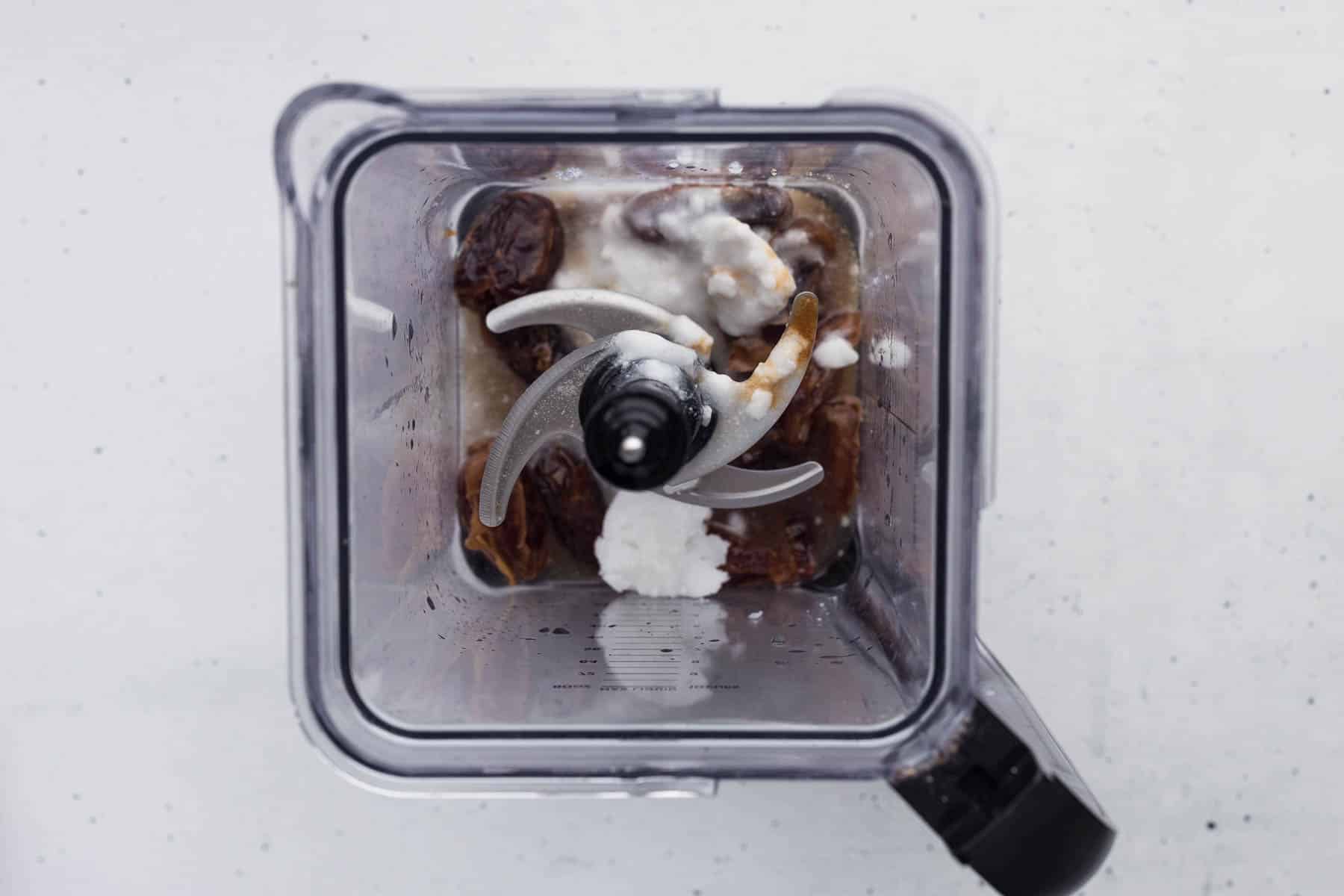 ingredients added to blender to make date caramel sauce for the date cake