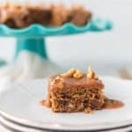 close up of Date Cake with Caramel Sauce on white plate