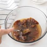Mashing the dates directly in the bowl using a fork until thick and caramel-like for the date cake