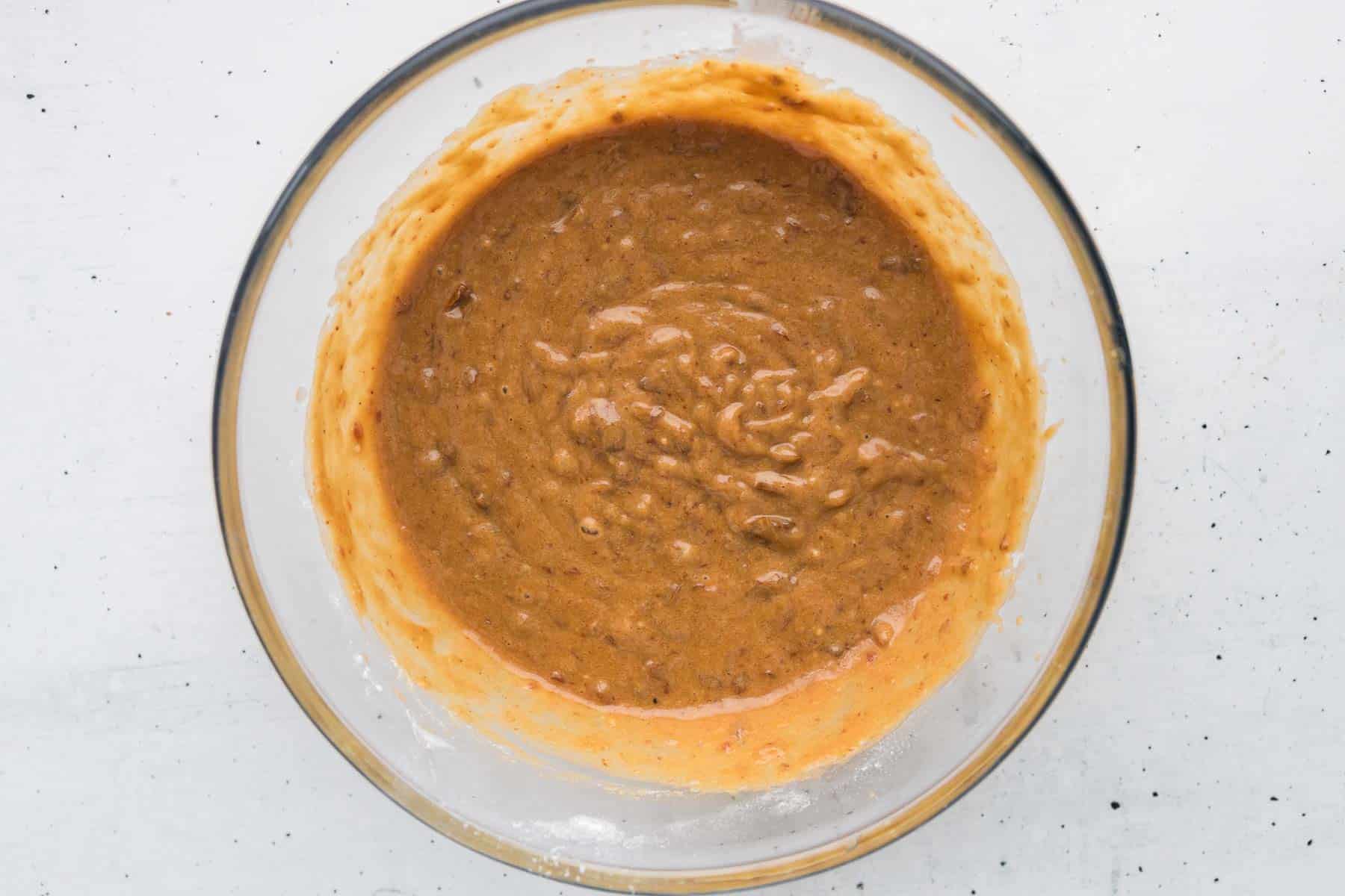 Add the mashed date mixture into the wet ingredients and stir to combine for the date cake