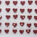 put red velvet cookie dough hearts on parchment lined baking sheet in the fridge to set