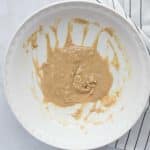 wet ingredients mixed in large white bowl for edible red velvet cookie dough hearts