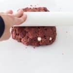 hand rolling edible cookie dough with rolling pin