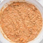 Fold in the shredded carrots and chopped walnuts for the mini carrot cakes