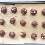 Scooping and rolling brownie batter into small energy balls