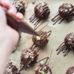 Drizzling melted chocolate over mini egg energy balls