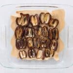 Medjool dates laid into a flat layer on parchment-lined tray
