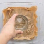 Pressing pitted Medjool dates into a flat layer with bottom of glass
